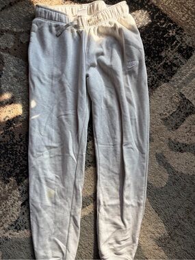 Nike women’s Light Gray Fleece Jogger Pants small stain on shin right leg
